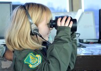 Madelyn Ray looks through binoculars in Osan Air Base’s air traffic control tower as part of a Pilot-for-a-Day program Feb. 17, 2012. Her tour consisted of learning to fly from a flight simulator and viewing the cockpits of an A-10 Thunderbolt II from the 25th Fighter Squadron, and an F-16 Fighting Falcon from the 36th FS. Her visit also allowed her to watch A-10s take off and land from Osan’s air traffic control tower, where a wave to an incoming pilot landed her a return wiggle-waggle from the Thunderbolt. (U.S. Air Force photo/Staff Sgt. Stefanie Torres)