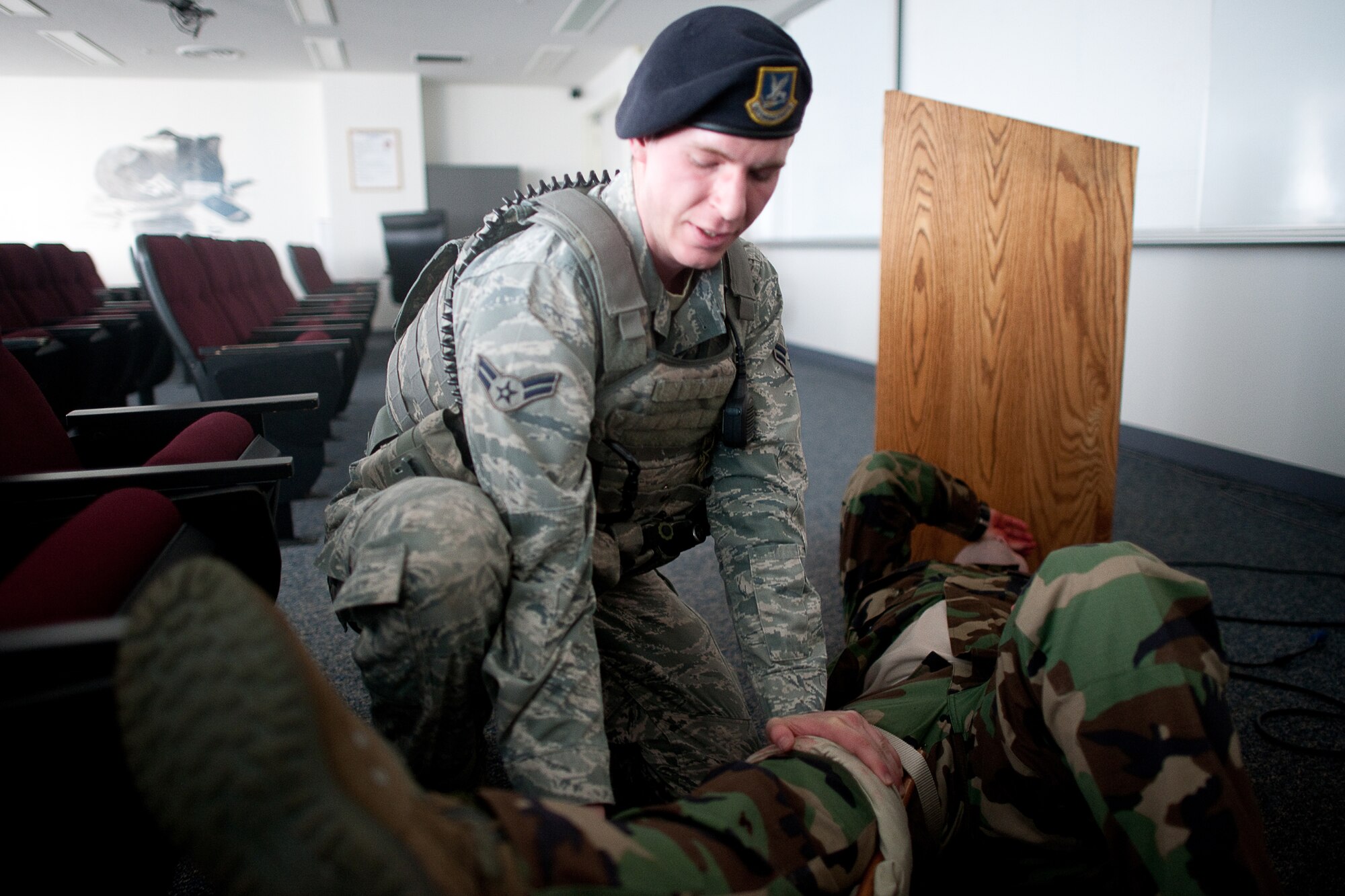 YOKOTA AIR BASE, Japan -- Airman 1st Class Colby Anderson, 374th Security Forces Squadron patrolman, performs self-aid and buddy care on a simulated victim during an active shooter scenario at Yokota Air Base, Japan, Feb. 21, 2012. Yokota is participating in a week-long exercise to maintain operational readiness capabilities. (U.S. Air Force photo/Osakabe Yasuo)