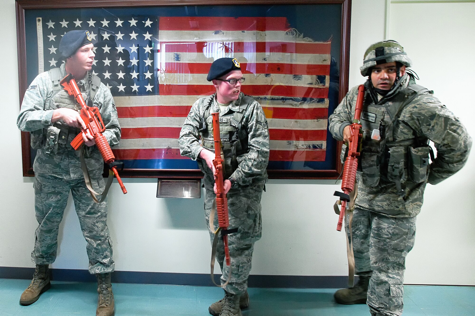 YOKOTA AIR BASE, Japan -- (left to right) Airman 1st Class Colby Anderson, A1C Andrew Landers, and Staff Sgt. Adorno Alvin, patrolmen from the 374th Security Forces Squadron, prepare to search and clear during an active shooter scenario at Yokota Air Base, Japan, Feb. 21, 2012. Yokota is participating in a week-long exercise to maintain operational readiness capabilities. (U.S. Air Force photo/Osakabe Yasuo)