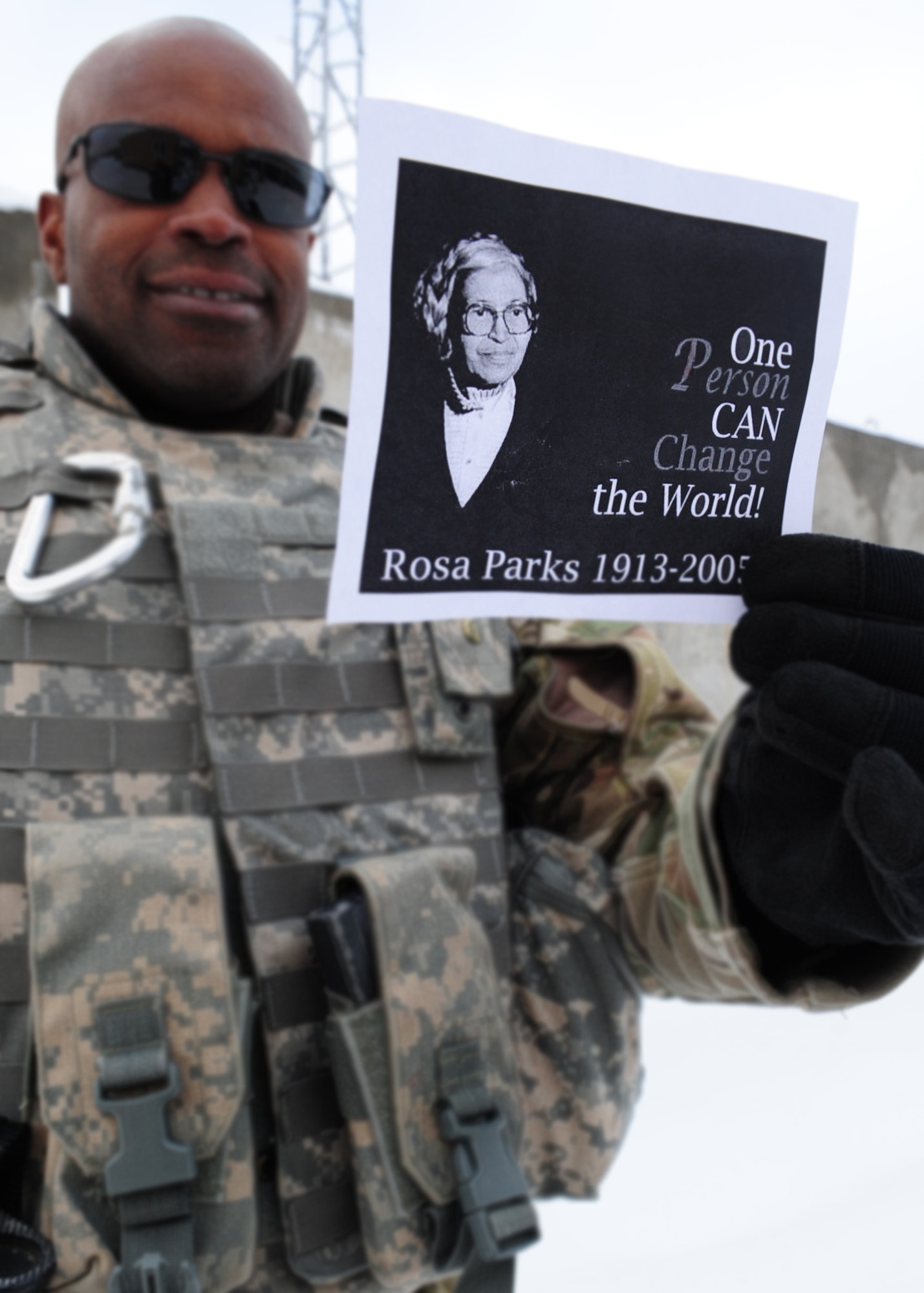 Maj. Anthony Graham, the Afghan Command Control Center advisor with the 438th Air Expeditionary Advisory Wing, holds a photo of Rosa Parks, the seamstress from Montgomery, Ala., whose defiance began a movement that ended legal segregation in America, Kabul International Airport, Feb. 21, 2012. Graham volunteers his off-duty time to live with and help mentor AAF pilot candidates; which includes some of the first females trained as pilots in Afghanistan.