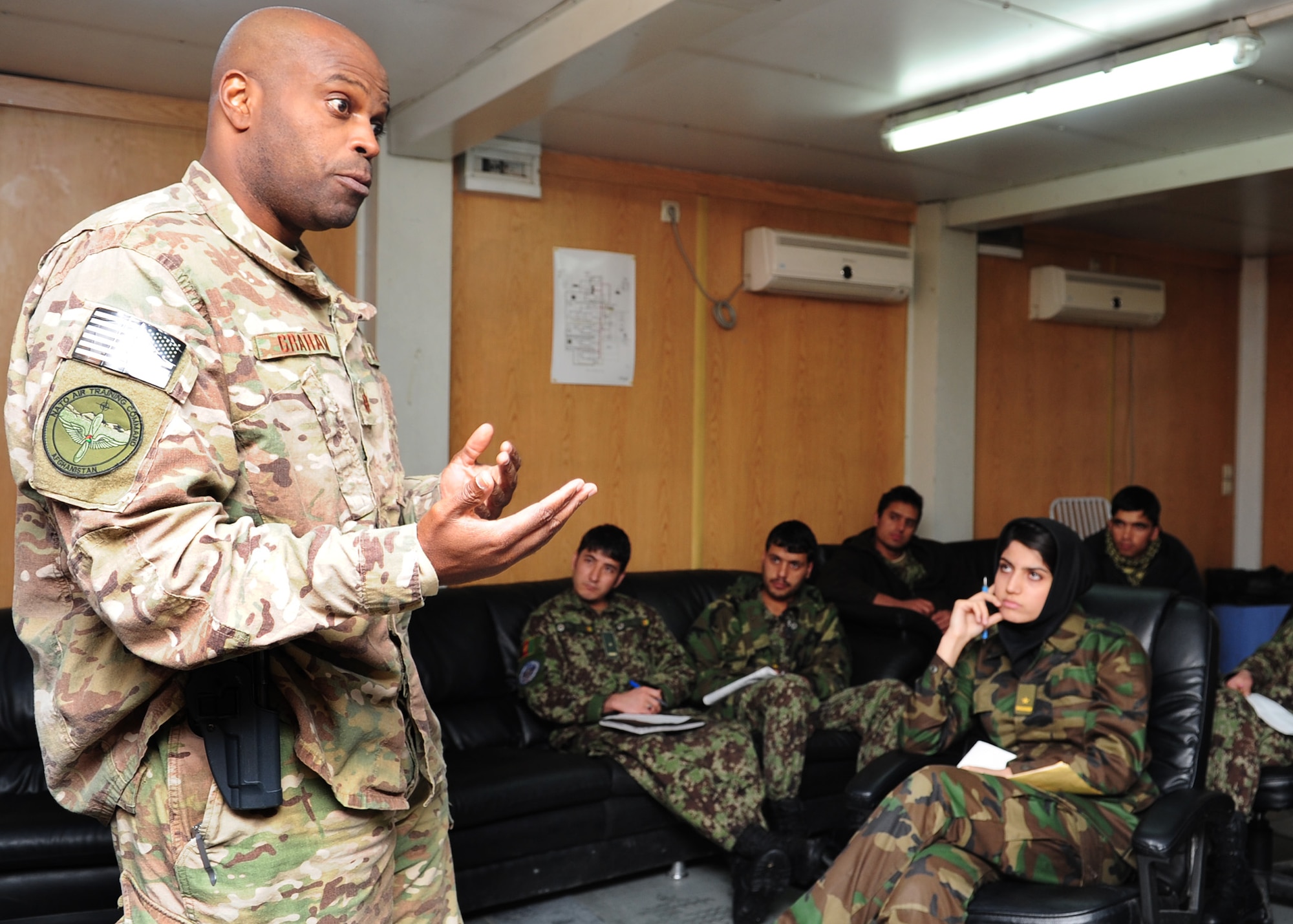 Maj. Anthony Graham, the Afghan Command Control Center advisor with the 438th Air Expeditionary Advisory Wing, gives a briefing on good communication within the military structure to Afghan air force pilot candidates during a leadership lesson at Kabul International Airport?s Thunder Lab, Feb. 20, 2012. Graham volunteers his off-duty time to live with and help mentor AAF pilot candidates; which includes some of the first females trained as pilots in Afghanistan.