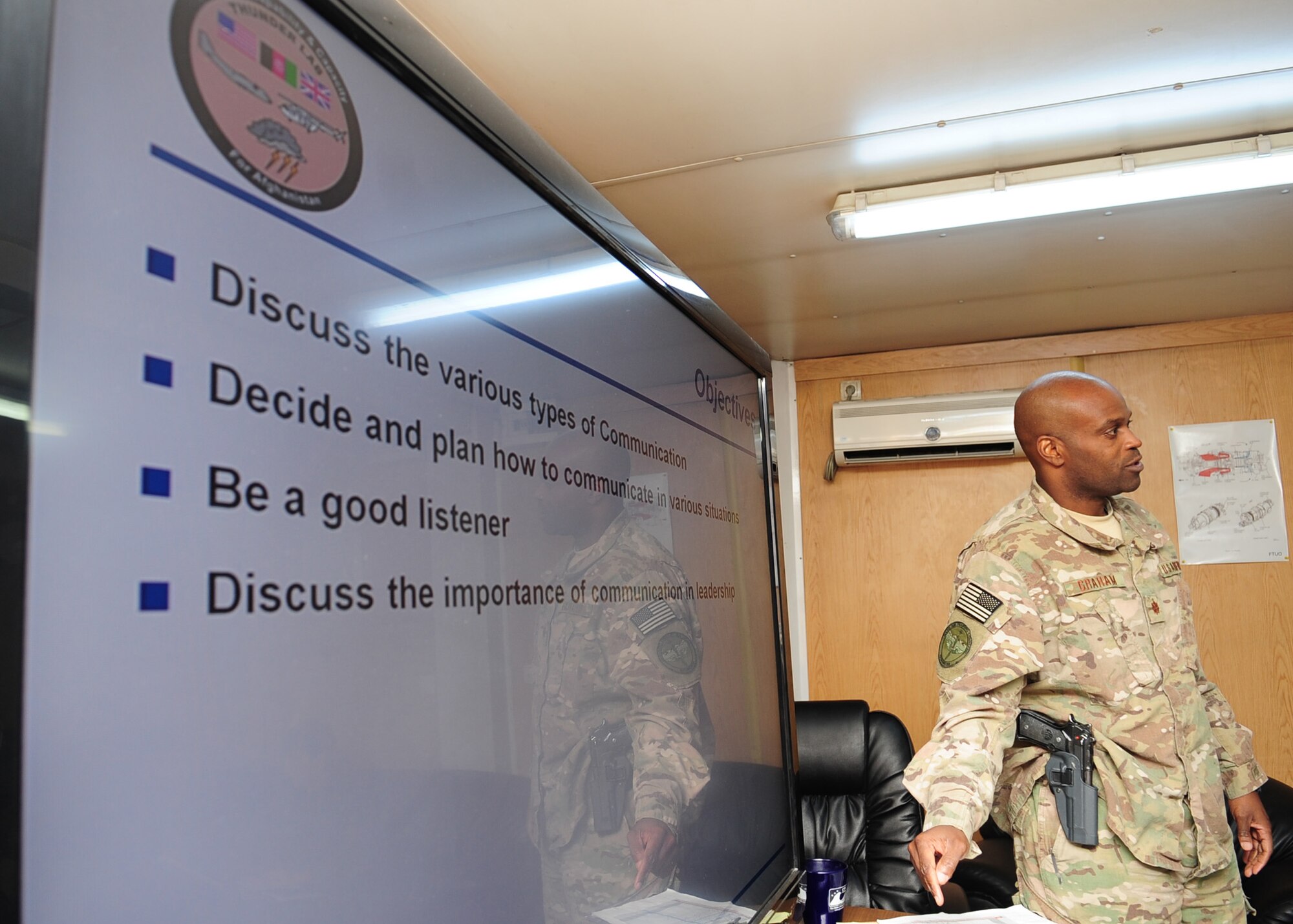 Maj. Anthony Graham, the Afghan Command Control Center advisor with the 438th Air Expeditionary Advisory Wing, gives a briefing on good communication within the military structure to Afghan air force pilot candidates during a leadership lesson at Kabul International Airport?s Thunder Lab, Feb. 20, 2012. Graham volunteers his off-duty time to live with and help mentor AAF pilot candidates; which includes some of the first females trained as pilots in Afghanistan.