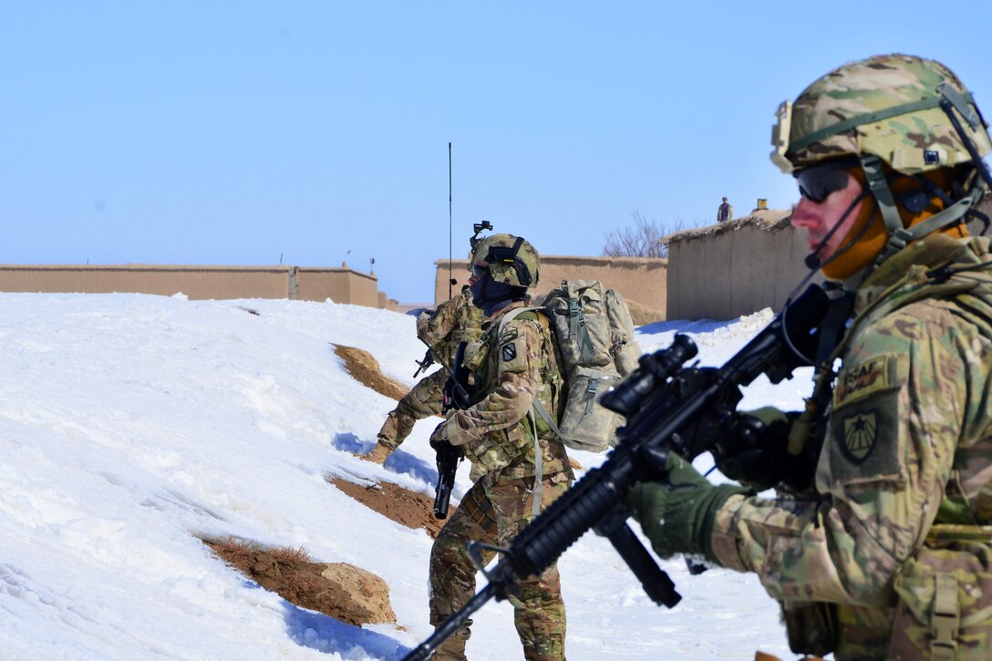 U.S. Army Capt. Patrick Foley, right, and Sgt. Brent Crutchfield, left, pull security during a patrol to the village of Haji Sultan, Afghanistan, Feb. 16, 2012. Foley and Crutchfield are assigned to the Zabul Agribusiness Development Team.