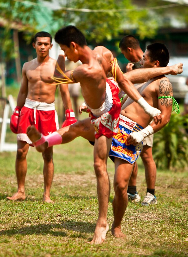 Thai Marines use a front hook kick during a sparring match to display their Muay Thai boxing skills during a sports multicultural exchange at the training area in Ban Chan Krem, Thailand, Feb. 15, 2012.