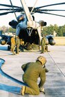 Marine Heavy Helicopter Squadron 461 crew members from the CH-53E Super Stallion pack their equipment and hoses up after completing a Forward Arming and Refueling Point mission at Blackstone Army Airfield, Dec. 13.