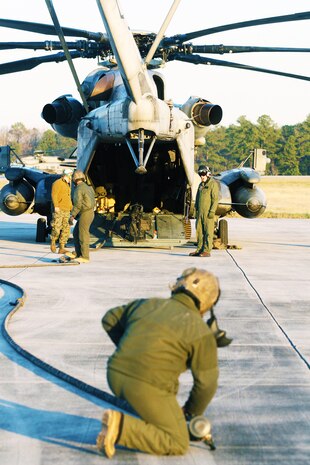 Marine Heavy Helicopter Squadron 461 crew members from the CH-53E Super Stallion pack their equipment and hoses up after completing a Forward Arming and Refueling Point mission at Blackstone Army Airfield, Dec. 13.