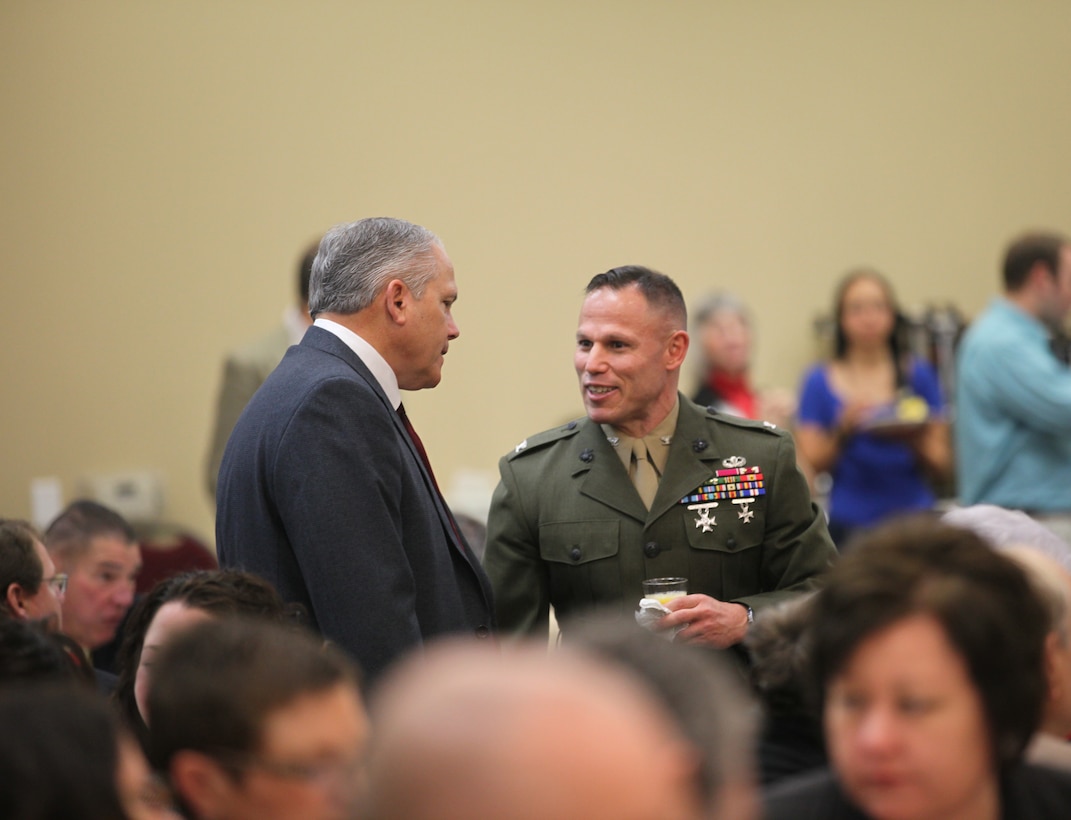 Col. Daniel J. Lecce speaks to a guest at the State of the Community Breakfast Feb. 14 in Jacksonville. Leaders gathered at the event to discuss changes throughout the community and its bases in the upcoming year.