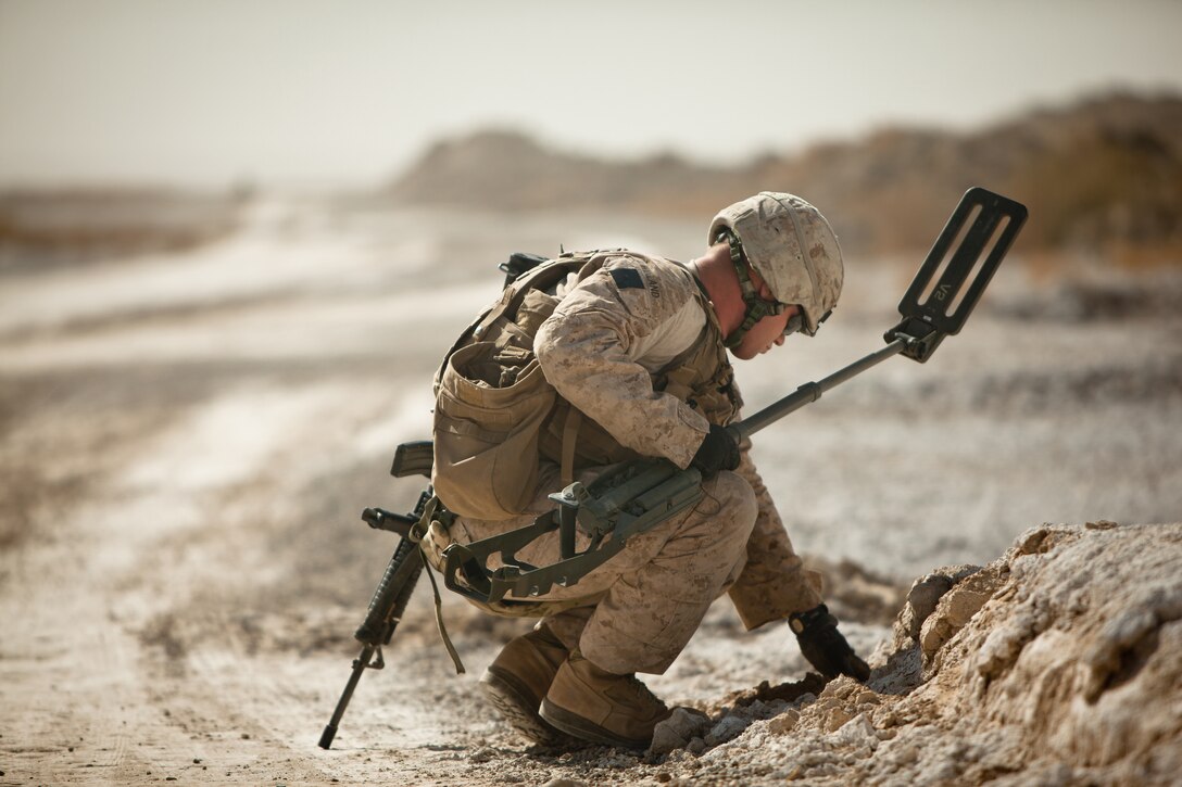 Lance Cpl. Bobby Winland, a combat engineer with Bridge Platoon, Alpha Company, 9th Engineer Support Battalion and a native of DeLeon Springs, Fla., checks for IED’s (Improvised Explosive Devices) before his platoon can move in and begin construction on a bridge near Combat Outpost Rankel in the district of Garmsir, Helmand province, Jan. 29. The Marines of Bridge Platoon endured a 5-day convoy in order to replace a temporary bridge with a more permanent structure that would increase mobility for Marines operating in the area.