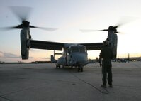 After the flight home, Cpl. Steven J. Syra, a Marines Medium Tilitrotor Squadron 365 MV-22B Osprey crew chief, helps shut down the aircraft. Marines of VMM-365 returned to their hangar from a training exercise in Belize, Sept. 19.