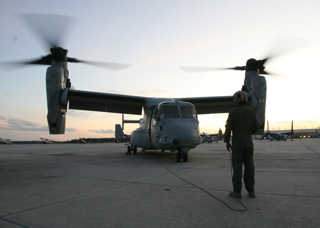 After the flight home, Cpl. Steven J. Syra, a Marines Medium Tilitrotor Squadron 365 MV-22B Osprey crew chief, helps shut down the aircraft. Marines of VMM-365 returned to their hangar from a training exercise in Belize, Sept. 19.