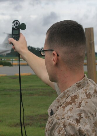 Sgt. Jason P. Lukasek, a weather forecster aboard Marine Corps Air Station New River, determines the approximate wind temperature.