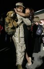 Lance Cpl. Adolfo J. Carrerocruz, Marine Wing Support Squadron 272 motor transport operator, embraces his significant other, after returning home from a seven-month deployment to Afghanistan. Approximately 250 Untouchables of MWSS-272 came home to Marine Corps Air Station New River in a homecoming event, Oct. 7.