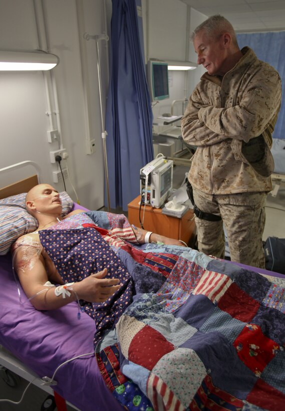 Maj. Gen. John A. Toolan, commanding general of Regional Command Southwest, visits with Sgt. Jacob P., a Danish tank commander with Jutland Dragoon Regiment, at the Role 3 Hospital aboard Camp Bastion, Feb. 1.  Jacob, a native of Holstebro, Denmark, sustained a gunshot wound to his right shoulder while providing overwatch during Operation Shamali Kamarband on Jan. 5.  Then on Jan. 31 he was wounded by three gunshot wounds, one to his right shoulder and two in his left leg.  On both occasions, Jacob remained calm under fire and instructed his crew to fire on the insurgents' position, killing them.