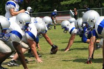 The New River Knights face off against one another before running a play at the practice field aboard Marine Corps Air Station New River, Aug. 23.