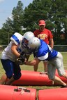 The New River Knights practice hitting drills to improve their tackling skills on the practice field aboard Marine Corps Air Station New River, Aug. 23. 
