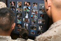 Marines from Marine Medium Tiltrotor Squadron 264, look at pictures of Staff Sgt. Thomas J. Dudley, before a memorial Aug. 26 for the beloved Marine who sacrificed his life in support of Operation Enduring Freedom.