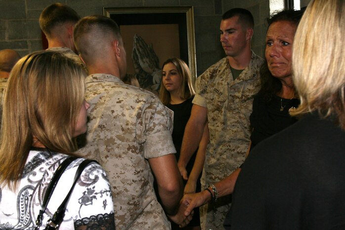 Friends and Marines from Marine Medium Tiltrotor Squadron 264 greet the family of Staff Sgt. Thomas J. Dudley after a memorial Aug. 26 for the Marine who sacrificed his life in support of Operation Enduring Freedom., Aug. 26.
