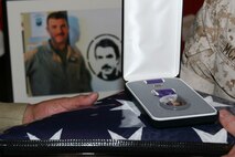Staff Sgt. Thomas J. Dudley's commanding officer thanks his father, Thomas A. Ulmer, for his son's sacrifice in support of Operation Enduring Freedom, after a memorial, Aug. 26.