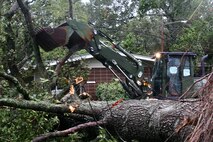 A Marine destructive weather cleanup crew clears a tree from a street aboard Marine Corps Air Station New River, N.C. following Hurricane Irene, Aug. 27, 2011. The aftermath of Hurricane Irene left a path of destruction aboard MCAS New River, N.C, and across coastal Carolina. 