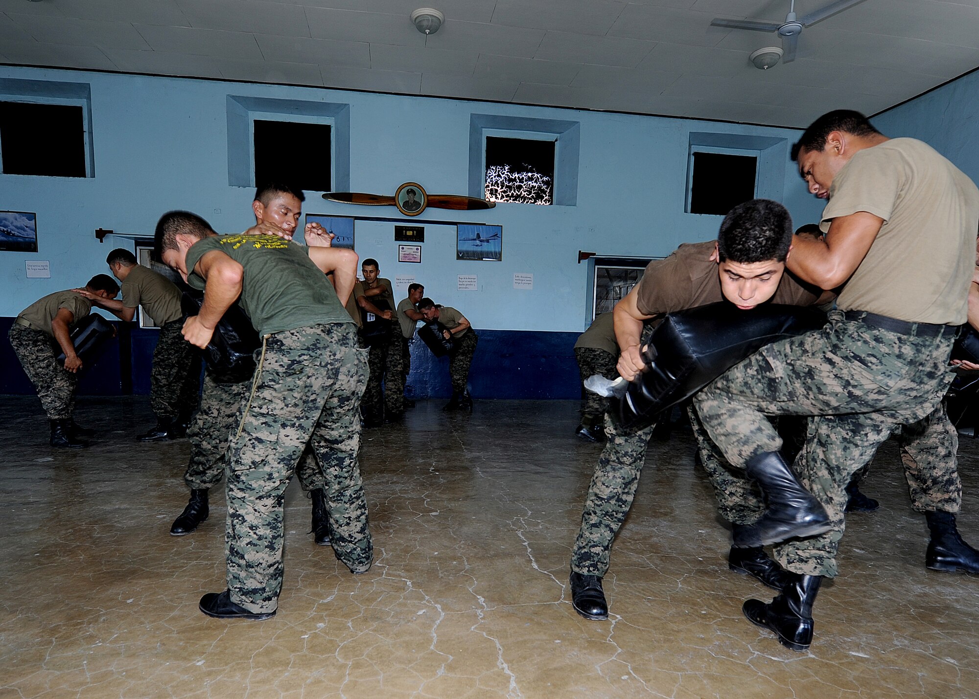 Honduran Air Force security forces members conduct knee strikes as part of the self-protection portion of the air base defense seminar Feb. 14, during the Air Mobility Command Building Partner Capacity mission in Tegucigalpa, Honduras.  (U.S. Air Force photo by Tech. Sgt. Lesley Waters)