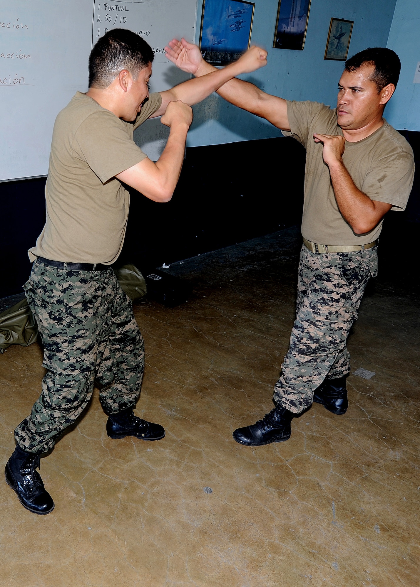 2nd Lt. Rene Aguilera and 2nd Lt. Carlos Amador, Honduran Air Force installation security officers, practice 360-degree defense as part of the self-protection portion of the air base defense seminar Feb. 14, during the Air Mobility Command Building Partner Capacity mission in Tegucigalpa, Honduras.  (U.S. Air Force photo by Tech. Sgt. Lesley Waters)