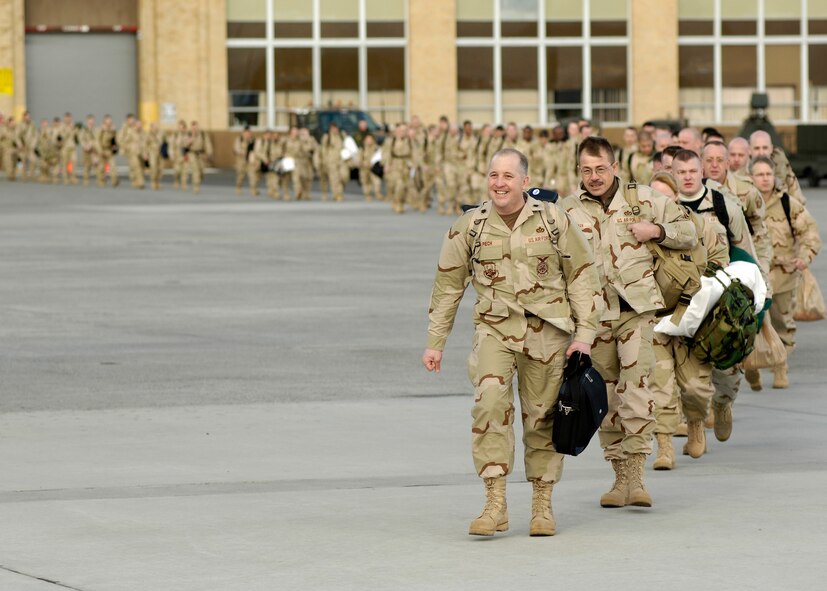 Lt. Col. David C. Piech, 92nd Civil Engineer Squadron commander at Fairchild Air Force Base, Wash., leads a contingent of 92nd Air Refueling Wing personnel across the Fairchild flightline on Jan. 11, 2006, to their departing aircraft. The deployers were gone for 120 days in support of the Global War on Terrorism. The group was destined for Sather Air Base in Baghdad, Iraq. (Courtesy photo)