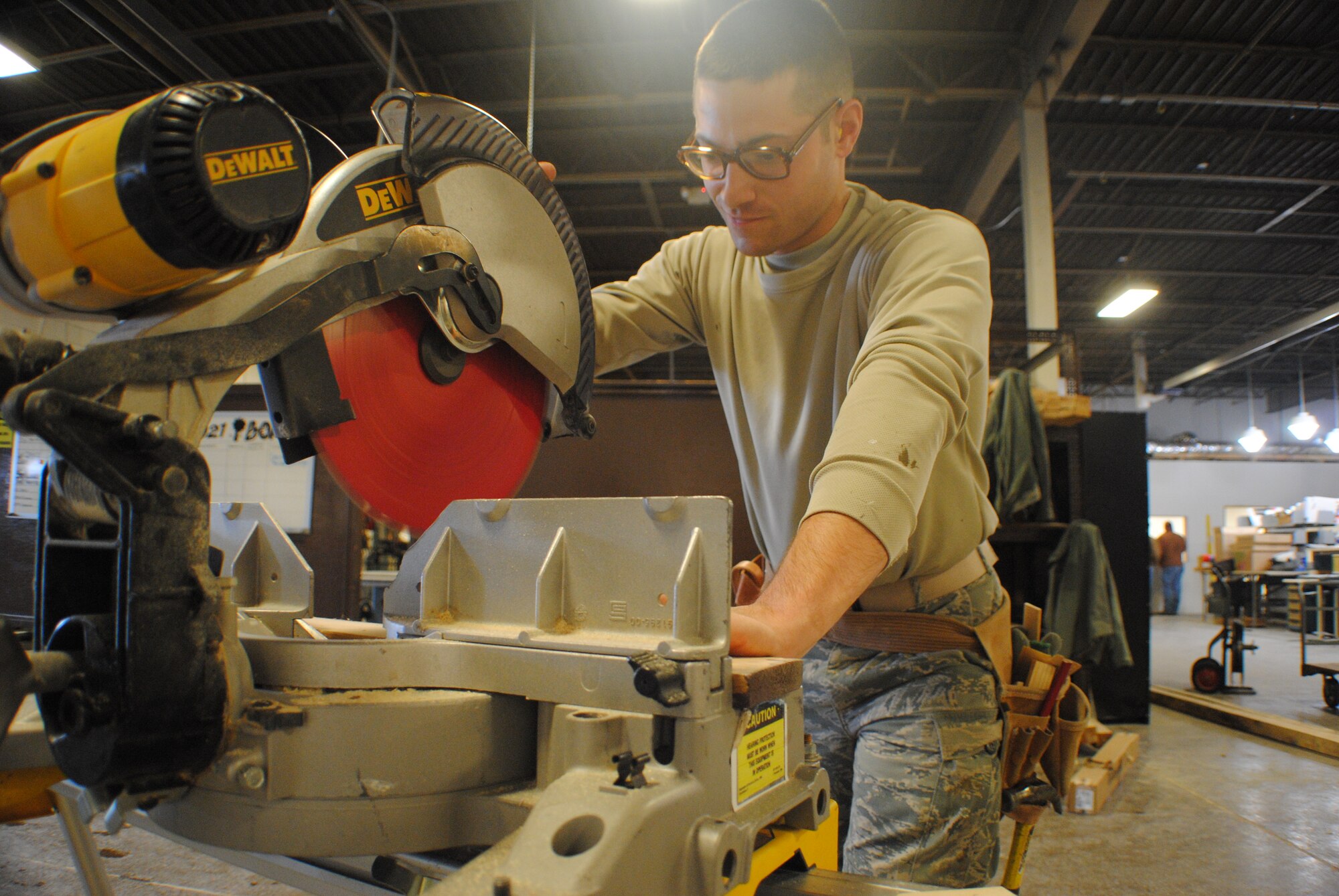 Airman 1st Class Adam Simmers of the 319th Civil Engineer Squadron cuts through a 1x4-inch piece of wood during a construction project for new offices being built inside Bldg. 408, Feb. 22, 2012, on Grand Forks Air Force Base, N.D.  Simmers has worked on more than 50 different projects since arriving to base eight months ago.  He was selected as the Warrior of Week for Grand Forks AFB for the week covering Feb. 19 to 24. (U.S. Air Force photo/Senior Airman Luis Loza Gutierrez)