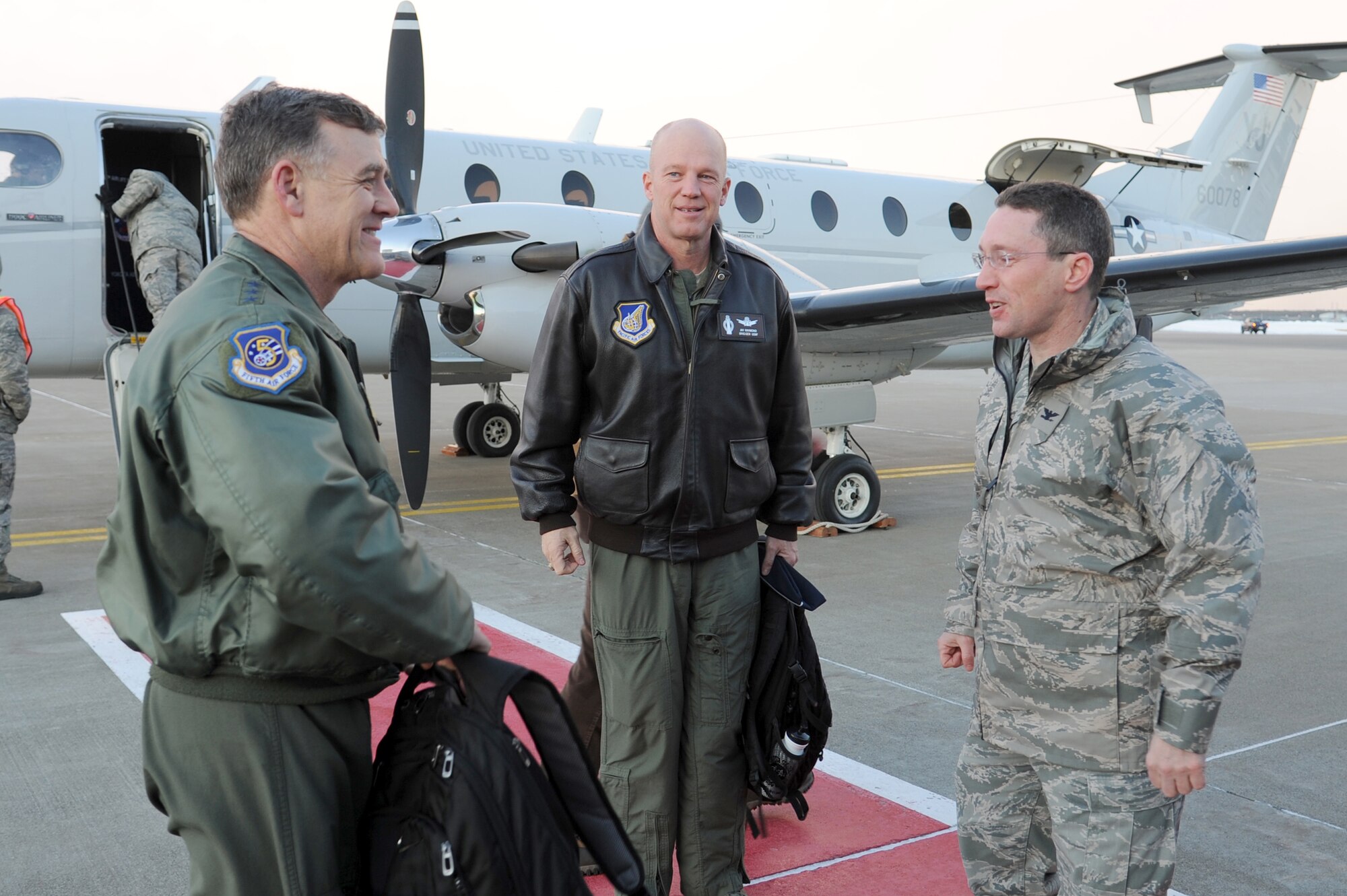 left to right: U.S. Air Force Lt. Gen. Burton Field, 5th Air Force commander, Brig. Gen. John Raymond, 5 AF vice commander, and Col. Michael Rothstein, 35th Fighter Wing commander, talk on the flightline at Misawa Air Base, Japan Feb. 16, 2012. Field, Raymond and their spouses traveled to Misawa AB to conduct aviation duties, tour base facilities and visit with Airmen and their spouses. (U.S. Air Force photo by Tech. Sgt. Marie Brown/Released)