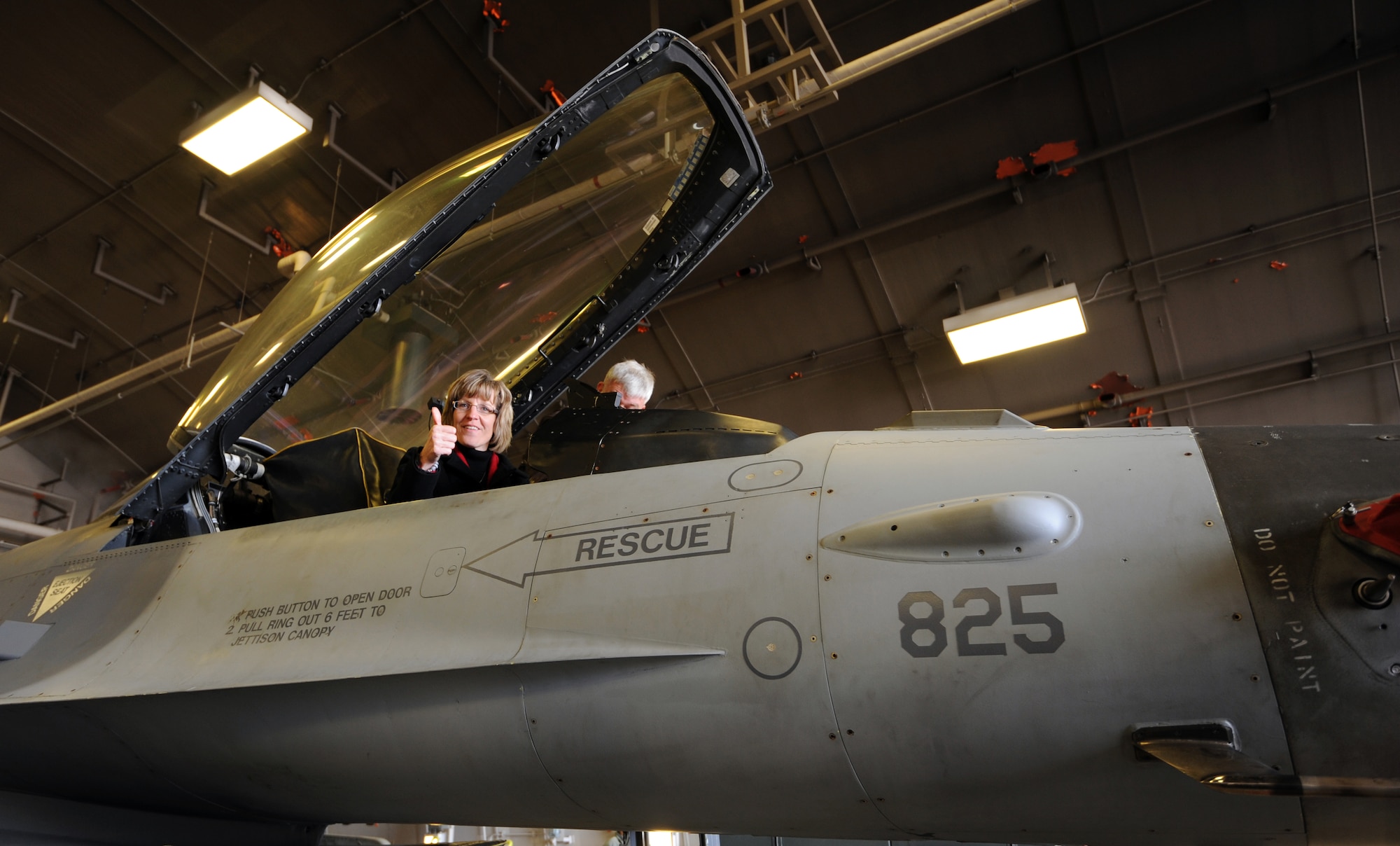 Mollie Raymond, wife of U.S. Air Force Brig. Gen. John Raymond, 5th Air Force vice commander, sits in the cockpit of an F-16 Fighting Falcon at Misawa Air Base, Japan, Feb. 17, 2012. Fifth Air Force leadership and their spouses traveled to Misawa to visit Airmen and attend a spouses' seminar, the Japan-America Air Force Goodwill Association ceremony and spouses' dining-in. (U.S. Air Force photo by Airman 1st Class Kia Atkins/Released)