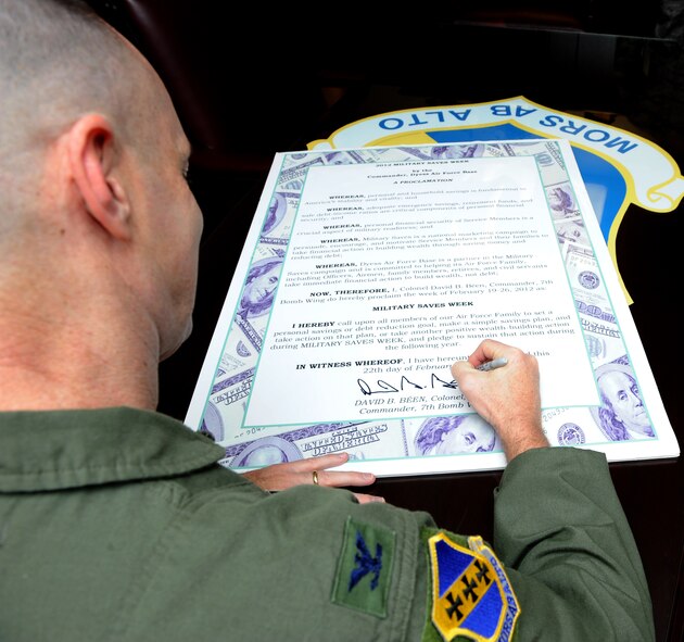 U.S. Air Force Col. David Been, 7th Bomb Wing commander, signs the Military Saves proclamation Feb. 22, 2012, at Dyess Air Force Base, Texas. Military Saves is a social marketing campaign to persuade, motivate and encourage military families to save money every month and to convince leaders and organizations to be aggressive in promoting automatic savings. The Military Saves Financial Education Information Fair and Seminars is scheduled to be held from 8:00 a.m. to 4:00 p.m. at the Heritage Club on Feb. 24, 2012. (U.S. Air Force photo by Airman 1st Class Jonathan Stefanko/ Released)