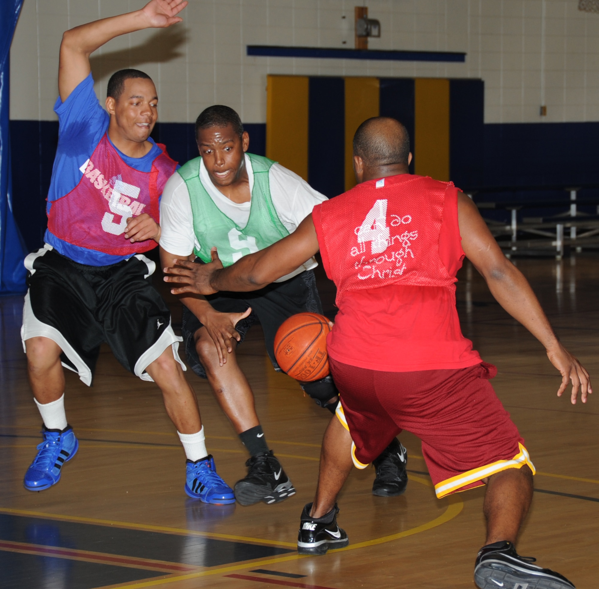 Matthew Smith and Leviticus Robinson, 81st Logistics Readiness Squadron, double team V.J. Peoples, 333rd Training Squadron, as he makes his way towards the basket during the intramural championship basketball game Feb. 16, 2012, at the Blake Fitness Center, Keesler Air Force Base, Miss.  The 81st LRS defeated the 333rd TRS 46-41.  (U.S. Air Force photo by Kemberly Groue)