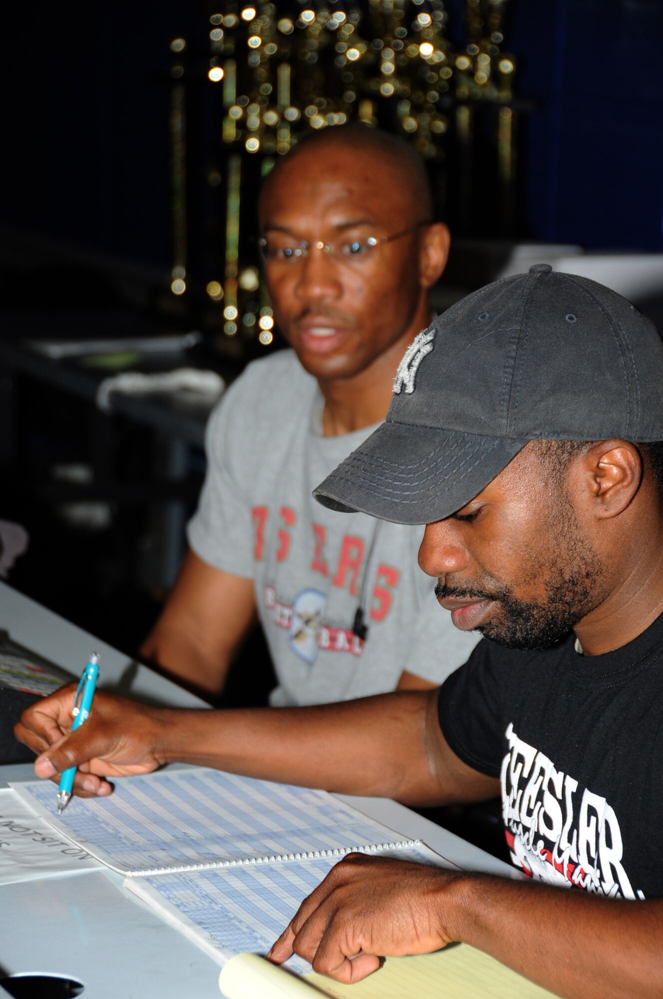 Sam Miller, intramural sports director, and Tech. Sgt. Gerald Peterson, 336th Training Squadron, keep stats in the score book and control the score board during the intramural championship basketball game between the 81st Logistics Readiness Squadron and the 333rd Training Squadron Feb. 16, 2012, at the Blake Fitness Center, Keesler Air Force Base, Miss.  The 81st LRS defeated the 333rd TRS 46-41.  (U.S. Air Force photo by Kemberly Groue)