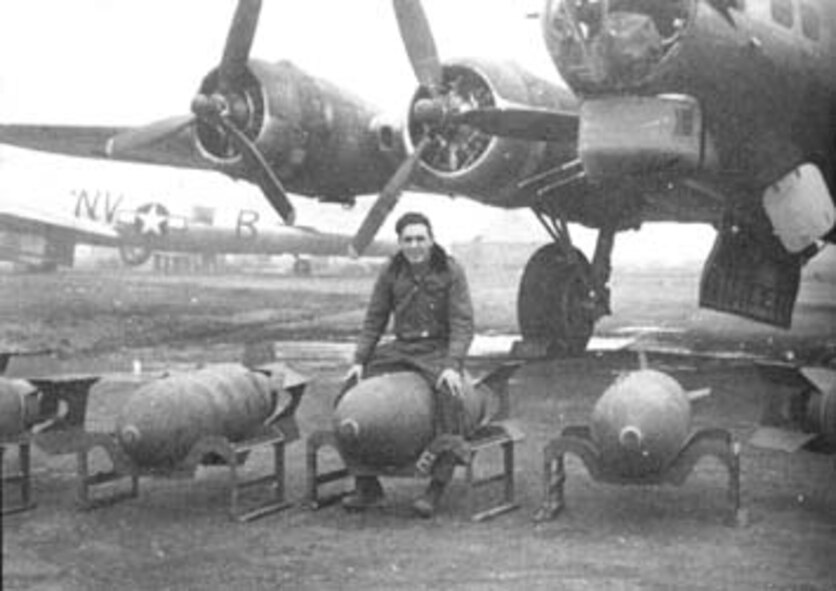 A 92nd Bombardment Group B-17 bomb loader is pictured by one of his bombs on a flightline in England in the early 1940s. The 92nd BG the legacy unit of the 92nd Air Refueling Wing now at Fairchild Air Force Base, Wash. (Courtesy photo) 