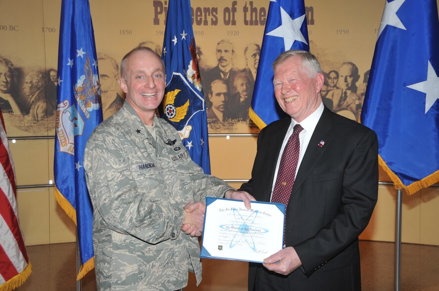 KIRTLAND AFB, N.M. -- Brig. Gen. Garrett Harencak, commander of the Air Force Nuclear Weapons Center, left, inducted Dr. John C. Hogan, retired Sandia National Laboratories senior scientist, into the ‘Order of the Nucleus’ on Feb. 16 at the National Museum of Nuclear Science & History. The award is presented to those who are supporting and have supported the nuclear enterprise with great distinction. (Photo by Todd Berenger)