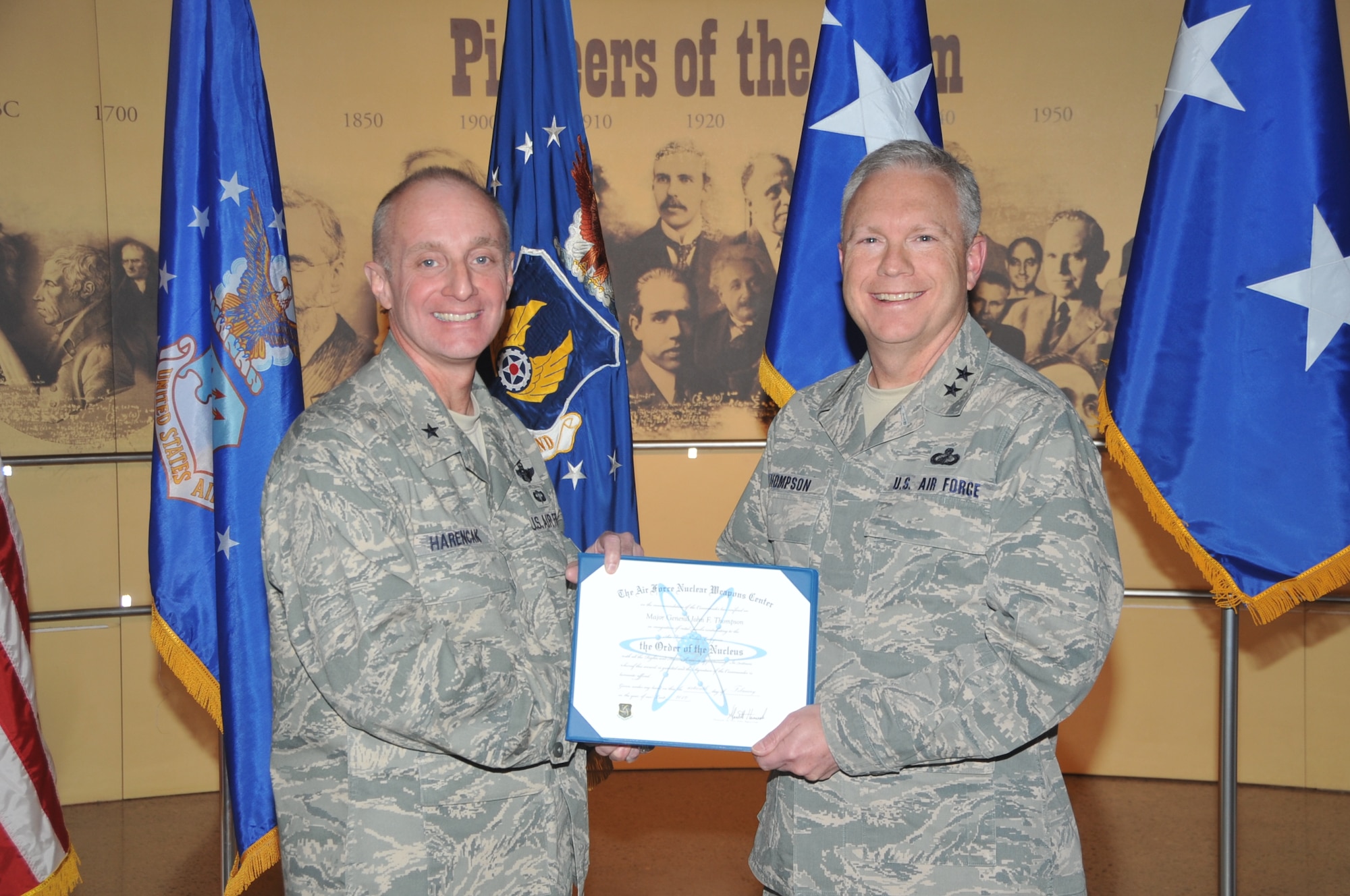 KIRTLAND AFB, N.M. -- Brig. Gen. Garrett Harencak, commander of the Air Force Nuclear Weapons Center, left, inducted Maj. Gen. John F. Thompson, who served as the Air Force Program Executive Officer for Strategic Systems from March 2010 to September 2011, into the ‘Order of the Nucleus’ on Feb. 16 at the National Museum of Nuclear Science & History. The award is presented to those who are supporting and have supported the nuclear enterprise with great distinction. (Photo by Todd Berenger)