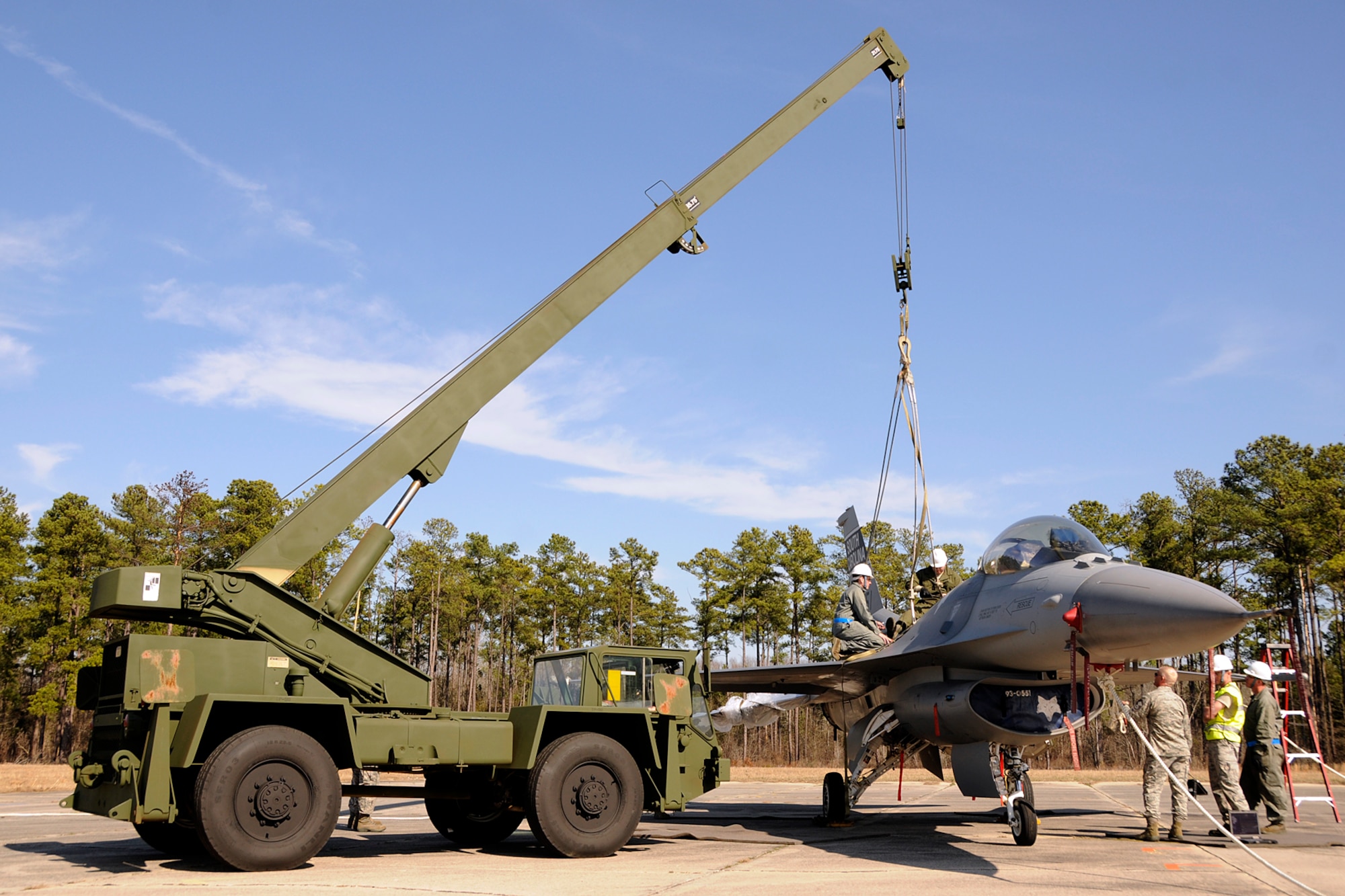 Crew Chiefs with the 169th Aircraft Maintenance Squadron at McEntire Joint National Guard Base, S.C., responds to a simulated aircraft mishap with a crashed F-16 fighter jet and UH-60 Black Hawk helicopter during a Crash, Damaged, Destroyed Aircraft Recovery (CDDAR) exercise on January 31, 2012.  The F-16 jet is connected to a crane to be transported from the accident sight. The training was important for all personnel involved due to the reality of the scenario, with the base sharing both air frames.
(SCANG photo by TSgt. Caycee Cook)
