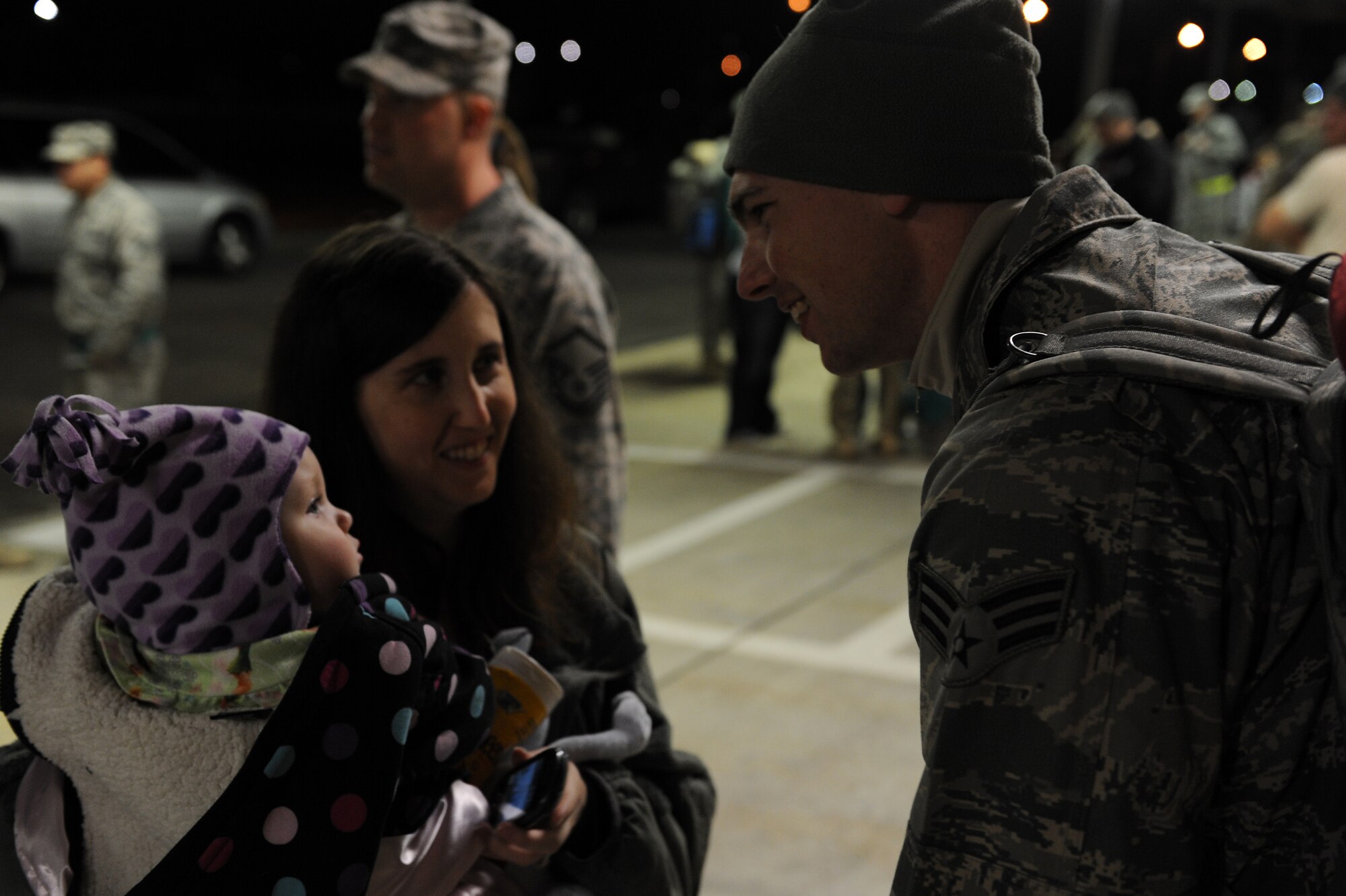 U.S. Air Force Senior Airman Paul Williams, 23d Maintenance Operations Squadron maintenance operations center, is greeted by his wife, Mandi, and daughter, Kaylee, after
returning from deployment Feb. 22, 2012, at Moody Air Force Base, Ga. Williams was one of 40 Airmen to return from a deployment to Afghanistan. (U.S. Air Force photo by Staff Sgt. Ciara Wymbs/Released) 
