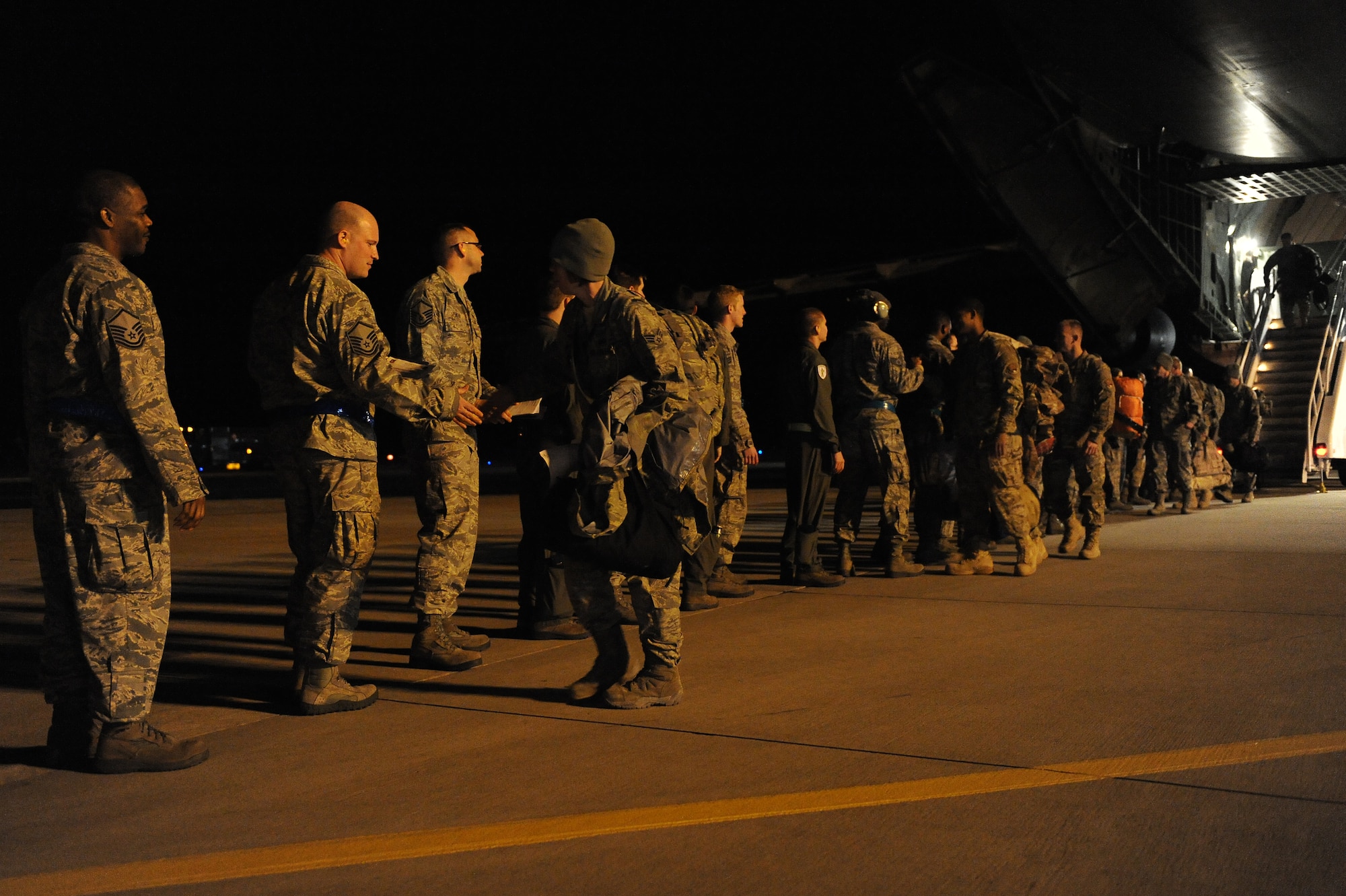 Coworkers and friends welcome home Airmen from the 723d Aircraft Maintenance Squadron at Moody Air Force Base, Ga., Feb. 22, 2012. The Airmen returned from a six-month deployment to Afghanistan. (U.S. Air Force photo by Staff Sgt. Ciara Wymbs/Released)  
