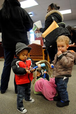 (From left to right) Two-year-old, Jordan Baldon, eight-month-old, Ariana Baldon and 20-month-old Richard Lee, Jr. keep entertained and play with bouncy-head pens while staying close to their mothers’ sides. The bouncy-head pens where one of several free goodies provided for guests during the first day of Military Saves Week, which took place Feb. 21, 2012, at the Airman and Family Readiness Center at Grand Forks Air Force Base, N.D.  Military Saves Week also featured activities for children as part of the campaign on base. (U.S. Air Force photo/Senior Airman Luis Loza Gutierrez)