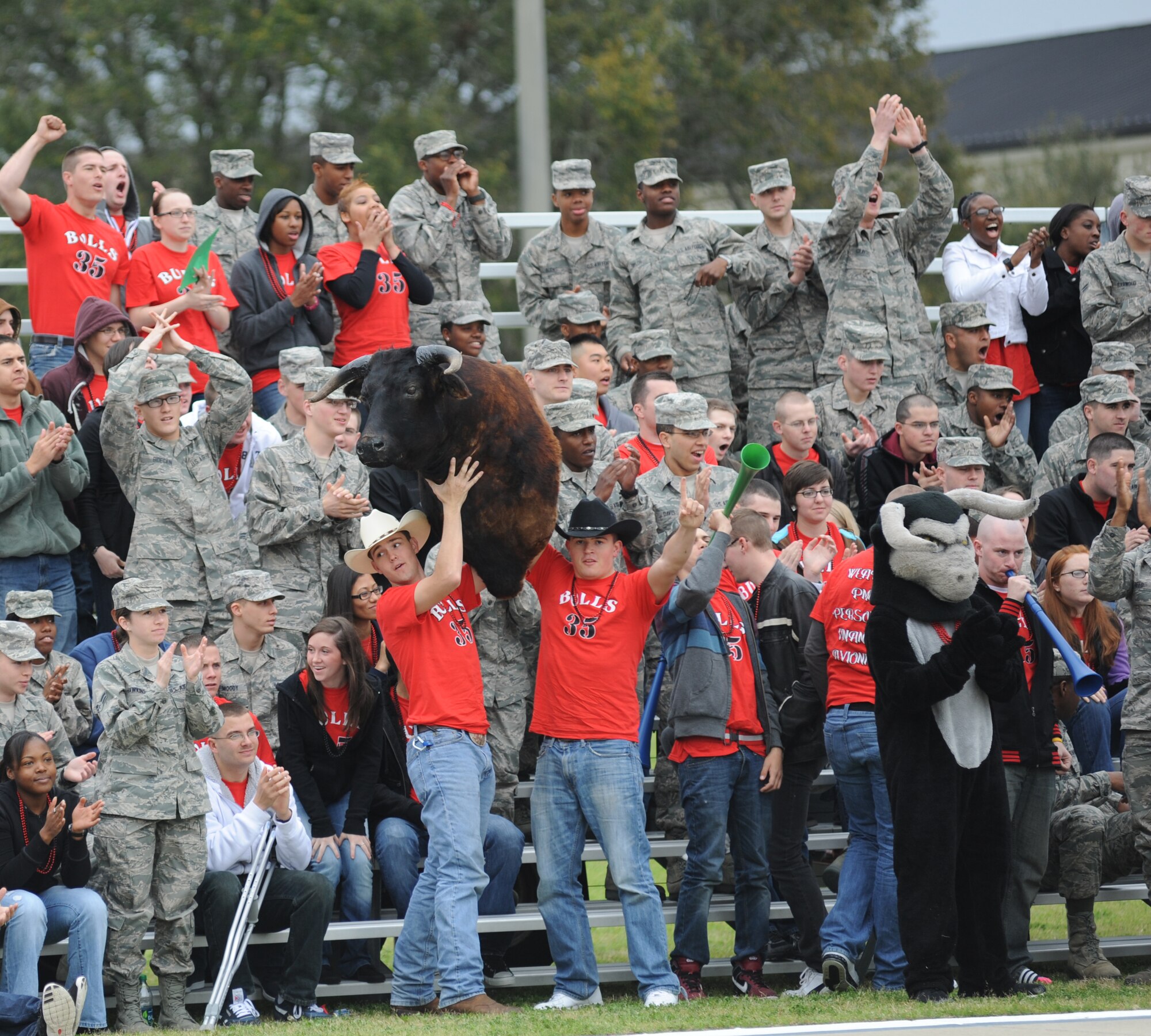Members of the 335th Training Squadron cheer on the Bulls’ drill team as they enter the field of freestyle drill competition Feb. 17, 2012, Keesler Air Force Base, Miss.  (U.S. Air Force photo by Kemberly Groue)