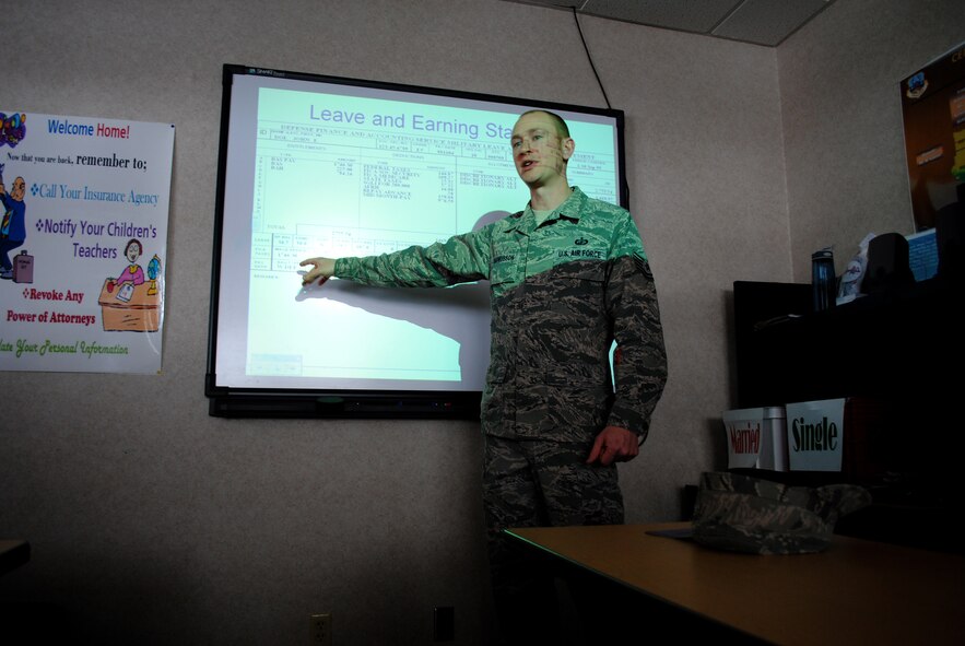 Tech. Sgt. Keelan Rasmusson, 319th Comptroller Squadron flight chief of financial analysis points the remarks section of a sample leave and earning statement for a service member.  Rasmusson presented a briefing and answered questions about military pay and entitlements during one of the educational and informative events during the first day of Military Saves Week, which took place Feb. 21, 2012 at the Airmen and Family Center at Grand Forks Air Force Base, N.D. (U.S. Air Force photo/Senior Airman Luis Loza Gutierrez)
