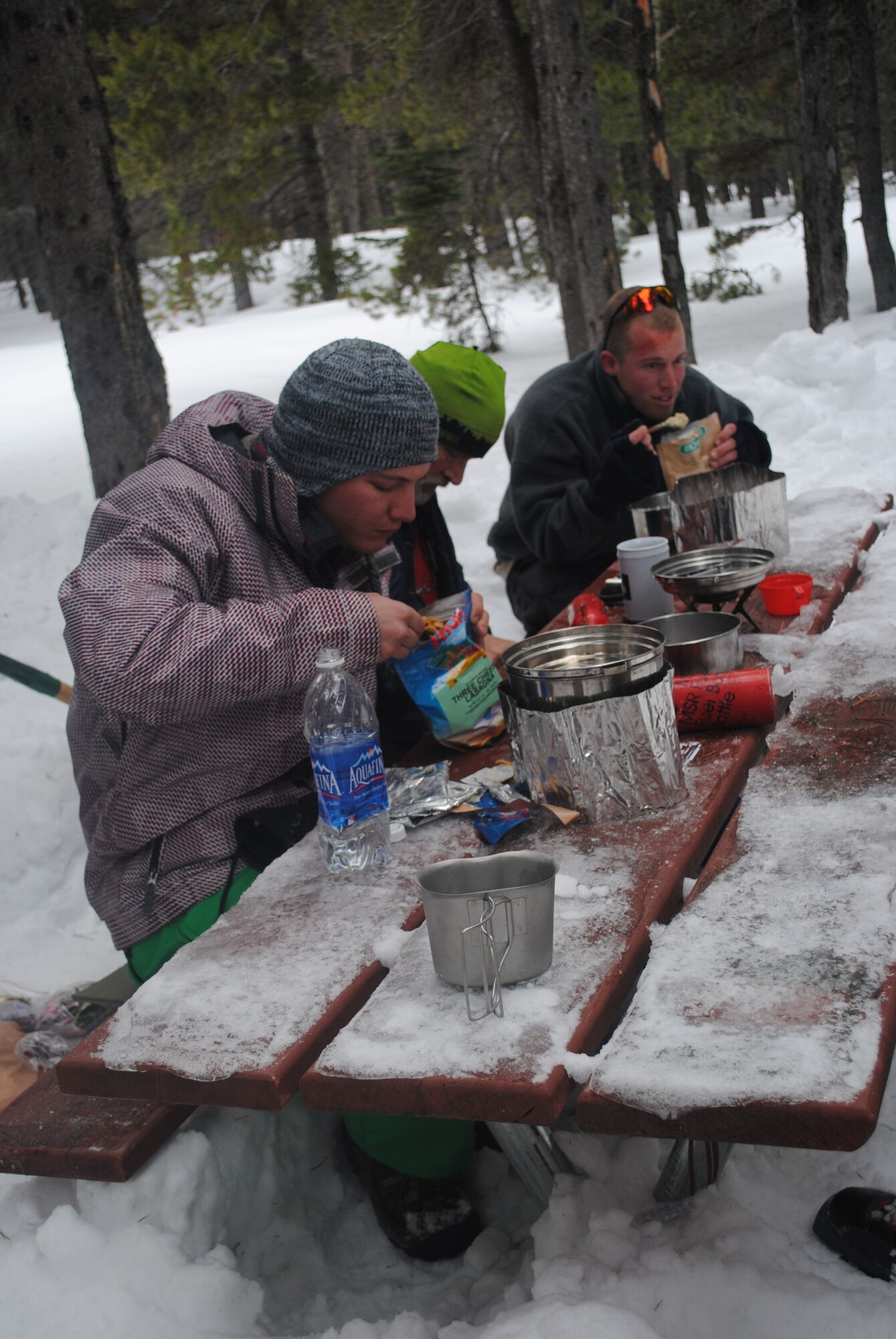 From left, Airman 1st Class Dean Beckley, 819th RED HORSE Squadron heavy equipment operator, Jim Beisel, Outdoor Recreation programmer and Airman 1st Class Tracy Wetzel, 819th RHS pavement and equipment operator, devour their breakfast. Airmen can sign up for Outdoor Recreation events by calling 731-3263.. (U.S. Air Force photo/Airman 1st Class Katrina Heikkinen)