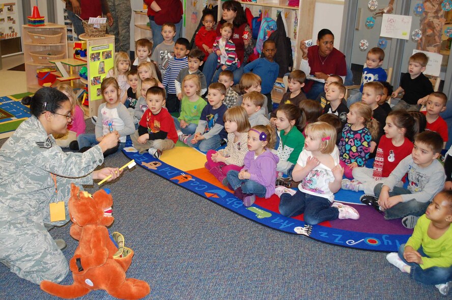 Staff Sgt. Shaleena Pulliam, 341st Medical Operations Squadron dental assistant, uses a timer to display how long a routine brushing should last. On Feb. 8, dental professionals from Malmstrom visited the Child Development and Youth Centers as part of Children's Dental Health Month. (U.S. Air Force photo/Senior Airman Reggie Manning)