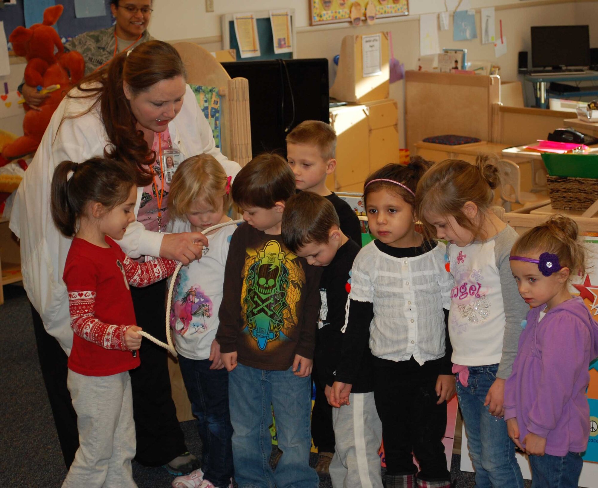 Mercy Padgett, 341st Medical Operations Squadron supervisory dental hygienist, stresses the importance of flossing to 24 students at the Child Development Center on Feb. 8, by using an interactive exercise with some members of the class. (U.S. Air Force photo/Senior Airman Reggie Manning)