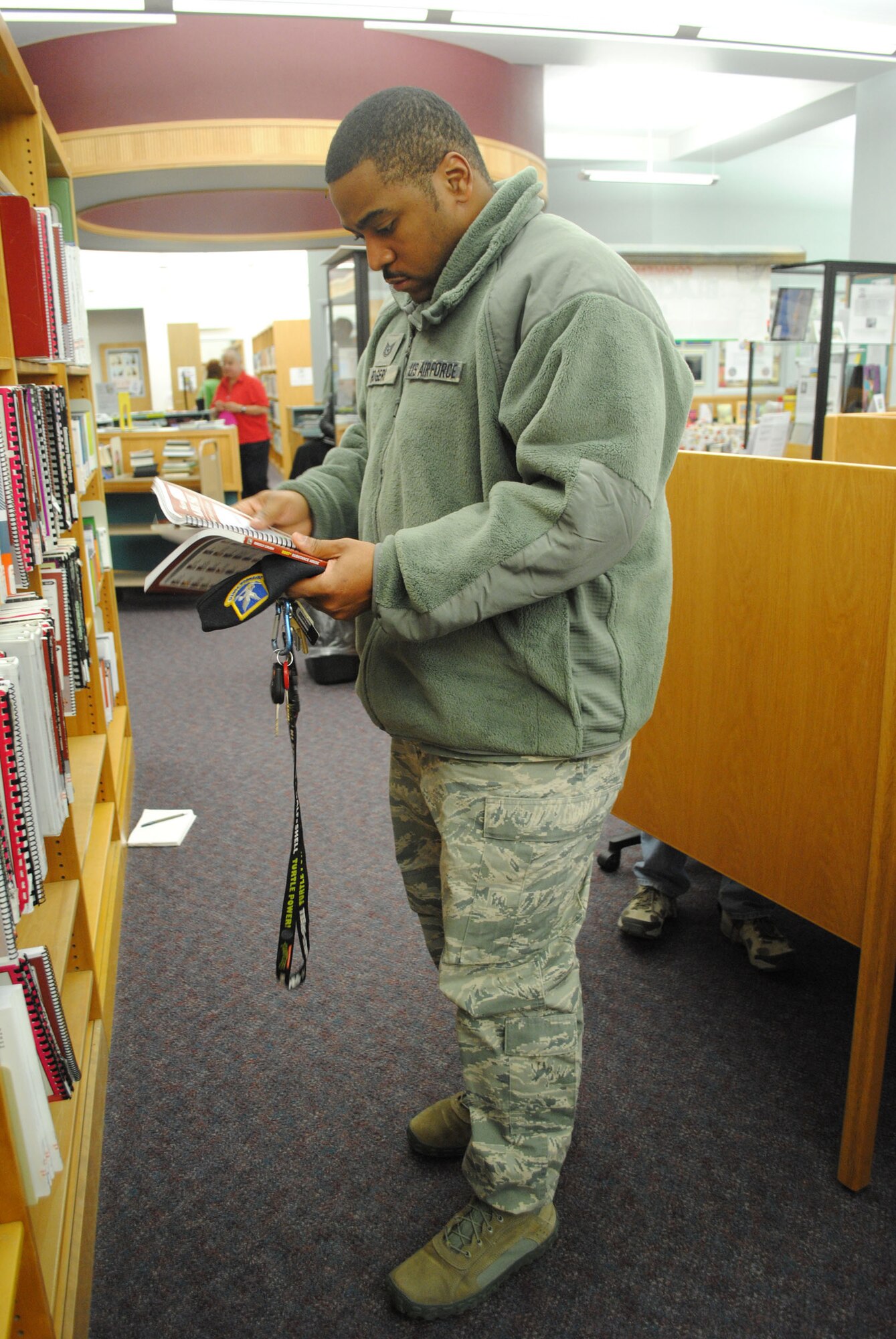 Tech. Sgt. David Rogers, 341st Security Forces Support Squadron keys and codes NCO in charge, browses CLEP study materials at the library. The library offers a variety in study material for CLEP and DSST testing in print, CD and DVD formats. (U.S. Air Force photo/Airman 1st Class Katrina Heikkinen)