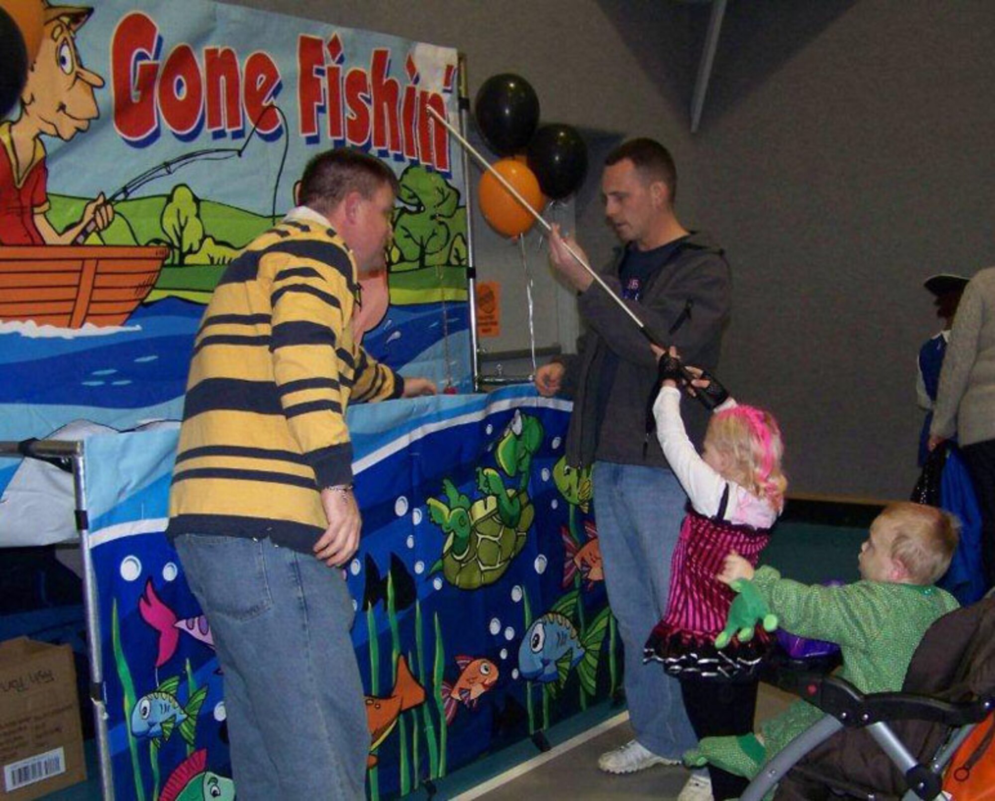 Families gathered at the Youth Center Oct. 28 to enjoy fun during the Fall Festival, including the fishing game. Youth Programs is considered a core activity and will not be affected by the downsizing. (Courtesy photo)