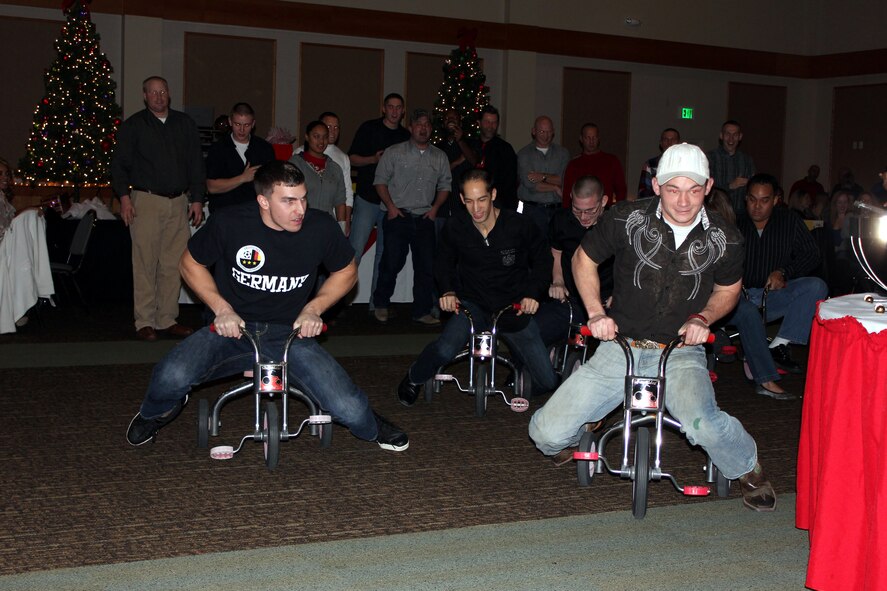Team Malmstrom Airmen prepare to race on tricycles during the 2011 Wing Holiday Party at the Grizzly Bend. (Courtesy photo)