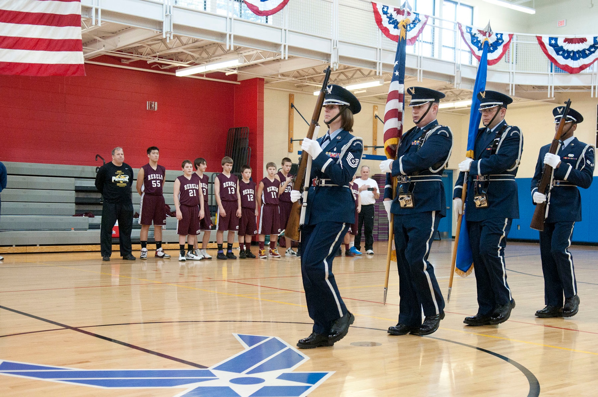 HANSCOM AIR FORCE BASE, Mass. – Members of the Goffstown Rebels look on as the Patriot Honor Guard present the colors prior to the tip off of the eighth grade championship basketball game between Goffstown, N.H., and Reading, Mass., during the Hanscom President’s Day Youth Basketball Tournament at the Fitness Center Feb. 19. Seventh and eighth grade travel basketball teams from New Hampshire and Massachusetts participated in the basketball tournament hosted by the Youth Center. (U.S. Air Force photo by Mark Wyatt)