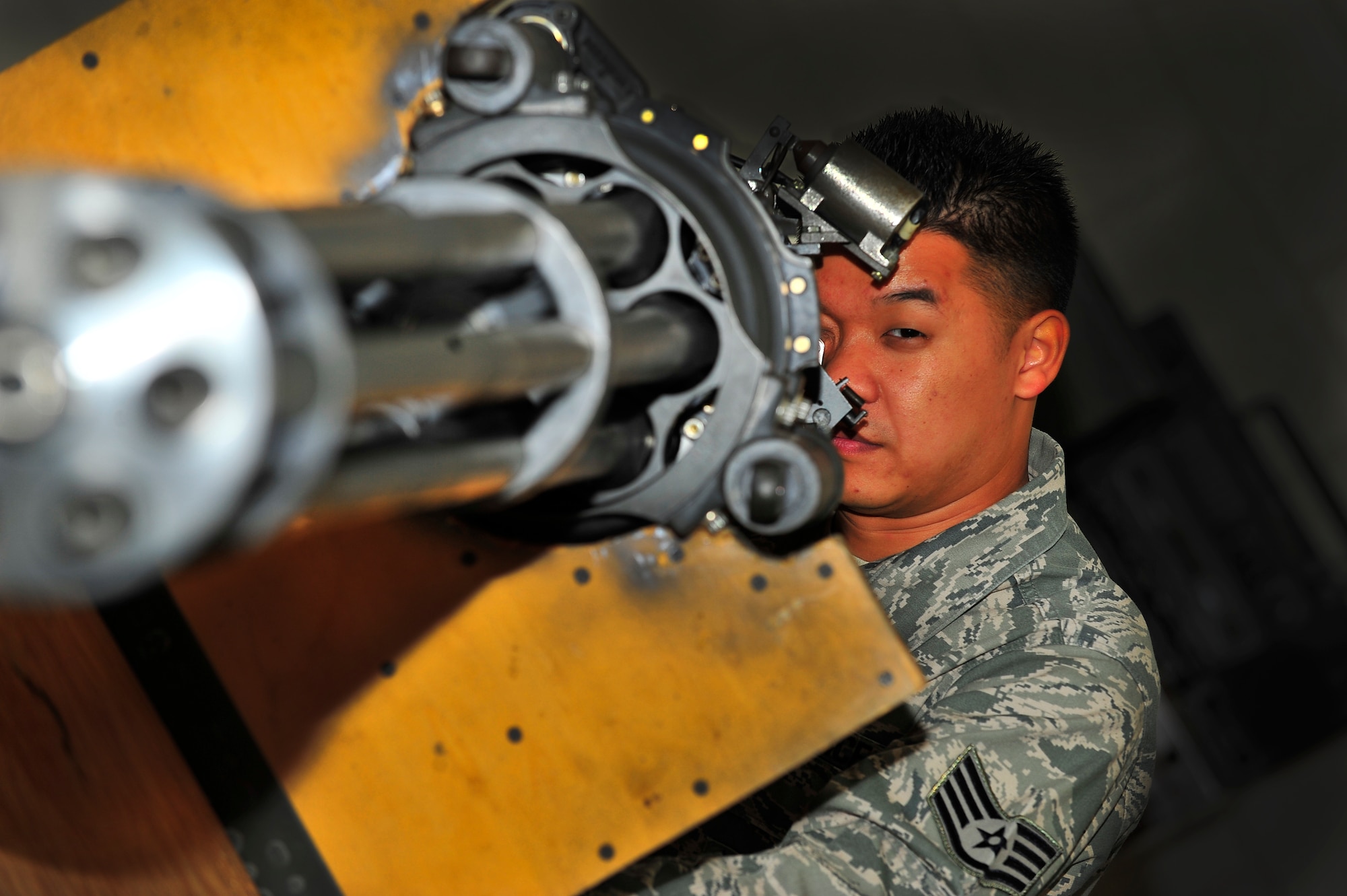 U.S. Air Force Staff Sgt. Thanh Nguyen, 372nd Training Squadron Detachment 202 F-16 armament systems instructor and scheduler, examines a M61A1 Vulcan cannon at Shaw Air Force Base, S.C. Feb. 22, 2012. Nguyen is the Warrior of the Week for Feb. 20-24. (U.S. Air Force photo/Senior Airman Neil D. Warner/Released)