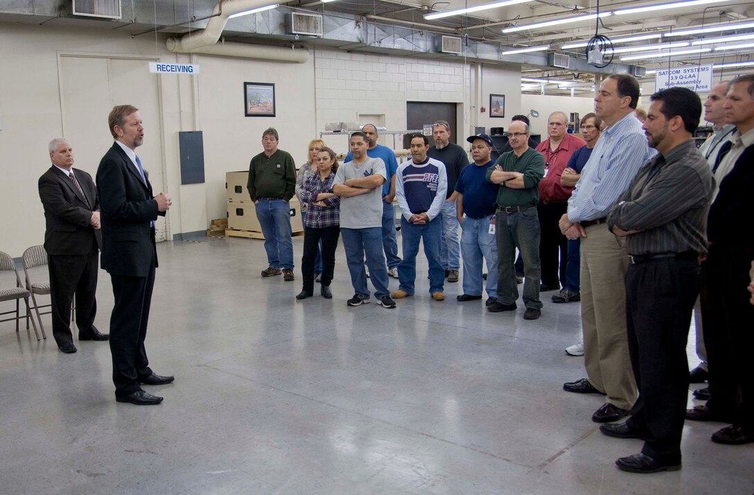 Scott Hardiman, Electronic Systems Center Space and Nuclear Networks Division acting chief, speaks to employees at L-3 Communications Microwave East in Hauppauge, N.Y., last month, while Gene Kelly (left), L-3 Narda president, looks on. ESC recently accepted the final Ground Multi-band Terminal from L-3, bringing the program to a successful production conclusion.  (Photo courtesy of L-3 Communications)